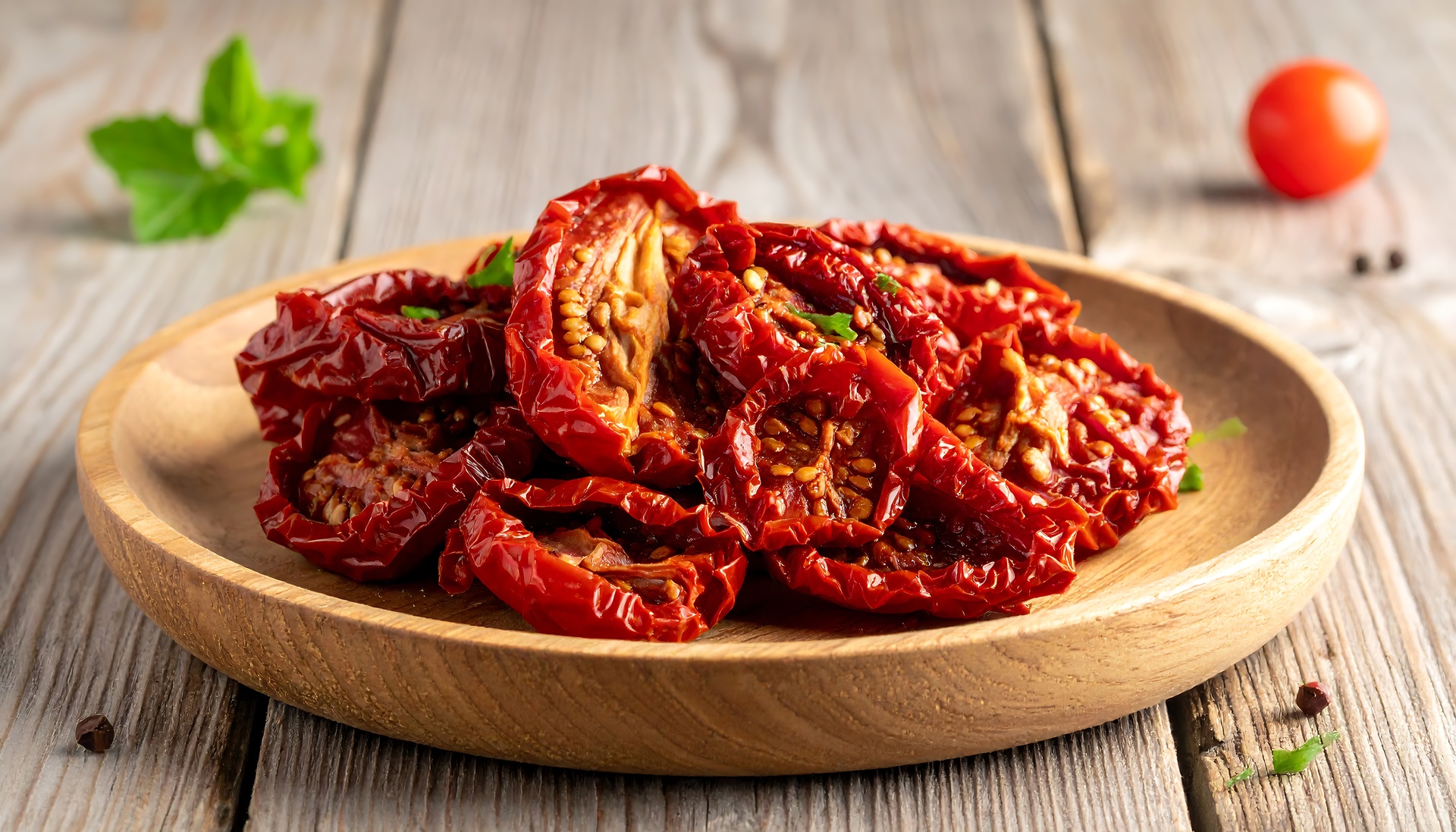 Sun-dried tomatoes in a wooden bowl for seasonal sourdough bread.