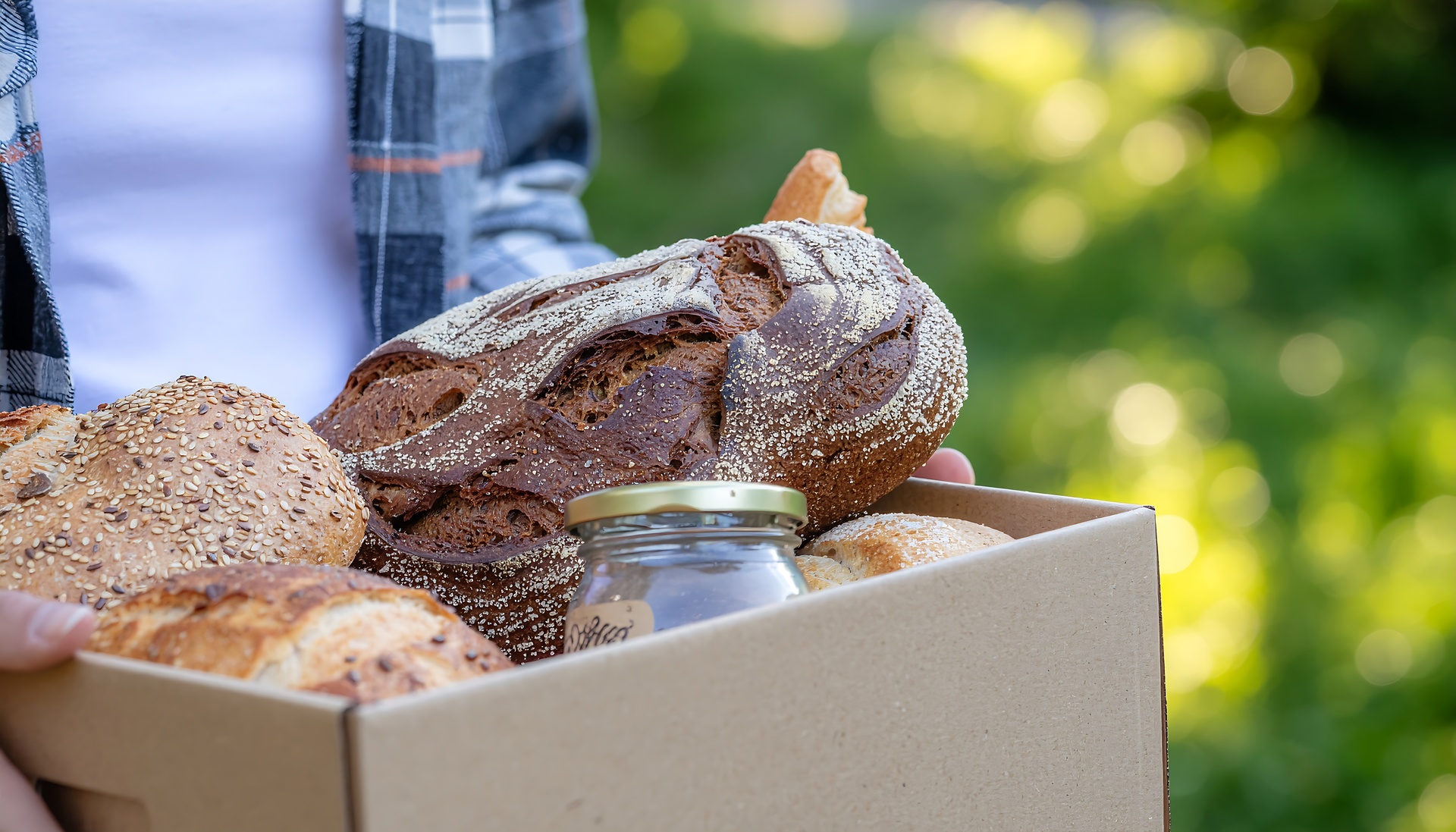 Box of fresh artisan bread for a wholesale bakery order.